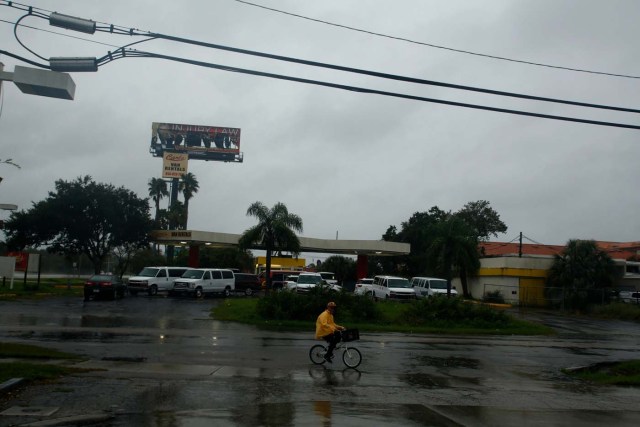 TAMPA, FL - SEPTEMBER 10: With the sky darkening and the wind picking up, a resident returns home on his bicycle after an unsuccessful last trip out of his home to find an open store selling food ahead of Hurricane Irma on September 10, 2017 in Tampa, Florida. Hurricane Irma made landfall in the Florida Keys as a Category 4 storm on Sunday, lashing the state with 130 mph winds as it moves up the coast.   Brian Blanco/Getty Images/AFP