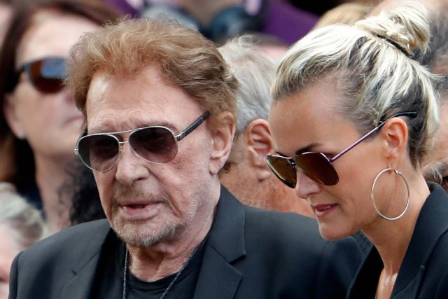 French singer and actor Johnny Hallyday (L) and his wife Laeticia attend the funeral ceremony of late actress Mireille Darc at the Saint-Sulpice church in Paris, France, September 1, 2017. REUTERS/Charles Platiau