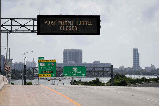 Signs warning of road closures are seen above the road in Miami Beach, Florida, U.S., September 8, 2017. REUTERS/Bryan Woolston