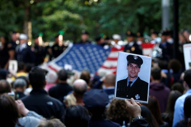 A person holds up a photograph of a victim at the National September 11 Memorial and Museum during ceremonies marking the 16th anniversary of the September 11, 2001 attacks in New York, U.S. September 11, 2017. REUTERS/Brendan McDermid