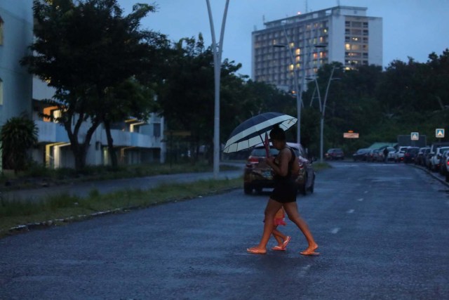 A woman crosses a street as Hurricane Maria approaches in Pointe-a-Pitre, Guadeloupe island, France, September 18, 2017. REUTERS/Andres Martinez Casares