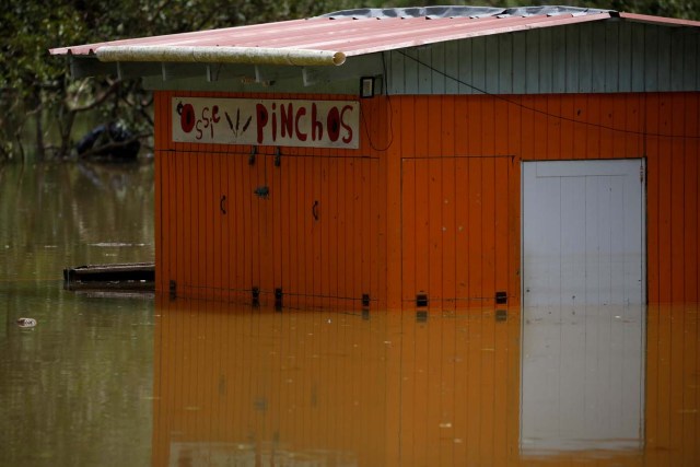 A restaurant submerged by flood waters is seen close to the dam of the Guajataca lake after the area was hit by Hurricane Maria in Guajataca, Puerto Rico September 23, 2017. REUTERS/Carlos Garcia Rawlins