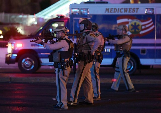 LAS VEGAS, NV - OCTOBER 02: Police officers point their weapons at a car driving down closed Tropicana Ave. near Las Vegas Boulevard after a reported mass shooting at a country music festival nearby on October 2, 2017 in Las Vegas, Nevada. A gunman has opened fire on a music festival in Las Vegas, leaving at least 2 people dead. Police have confirmed that one suspect has been shot. The investigation is ongoing.   Ethan Miller/Getty Images/AFP