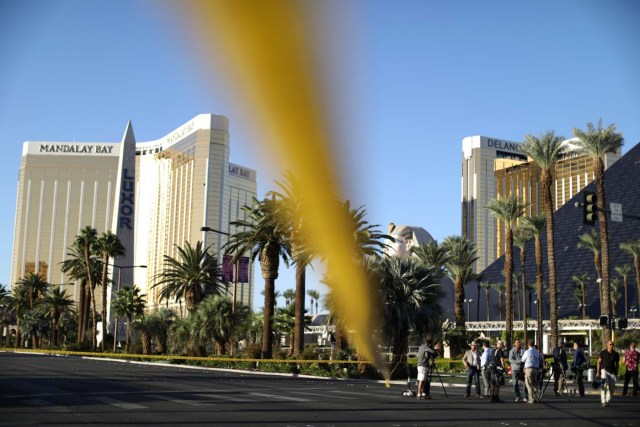 News crews stand in front of the closed Las Vegas Strip next to the site of the Route 91 music festival mass shooting outside the Mandalay Bay Resort and Casino in Las Vegas, Nevada, U.S., October 3, 2017. REUTERS/Lucy Nicholson