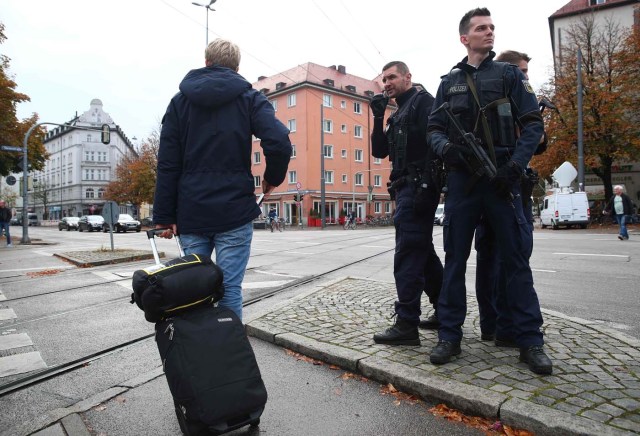 German police officers guard the site where earlier a man injured several people in a knife attack in Munich, Germany, October 21, 2017.