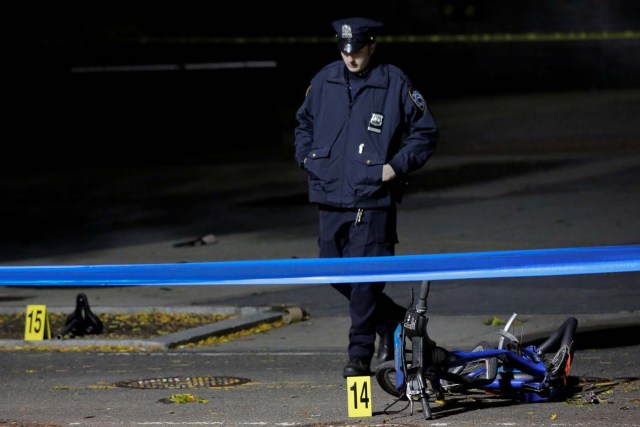 A police officer investigates crushed bicycles on a bicycle lane the day after a pickup truck attack on the West Side Highway in Manhattan, New York, U.S., November 1, 2017. REUTERS/Andrew Kelly