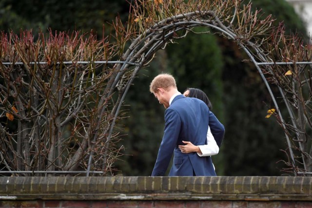 Britain's Prince Harry poses with Meghan Markle in the Sunken Garden of Kensington Palace, London, Britain, November 27, 2017. REUTERS/Toby Melville