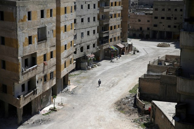 Abu Malek, one of the survivors of a chemical attack in the Ghouta region of Damascus that took place in 2013, uses his crutches to walk along a street in the Ghouta town of Ain Tarma, Syria April 7, 2017. REUTERS/Bassam Khabieh/File Photo     SEARCH "POY GLOBAL" FOR THIS STORY. SEARCH "REUTERS POY" FOR ALL BEST OF 2017 PACKAGES.    TPX IMAGES OF THE DAY