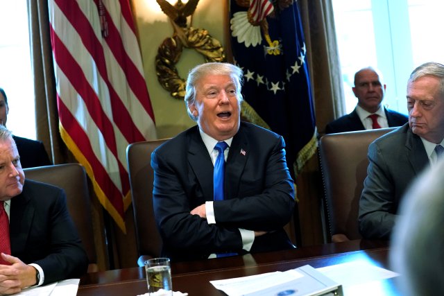 U.S. President Donald Trump, flanked by Deputy Secretary of State John Sullivan (L) and Defense Secretary James Mattis (R), speaks to reporters before he holds a cabinet meeting at the White House in Washington, U.S. December 6, 2017. REUTERS/Jonathan Ernst