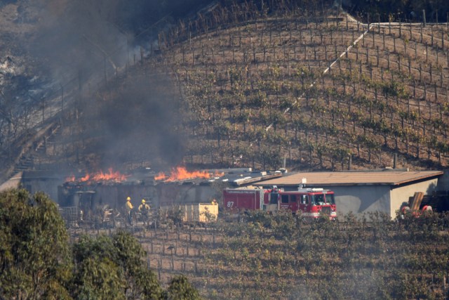 A building on the vineyard estate of media mogul Rupert Murdoch catches fire during the Skirball fire in Bel Air, a wealthy neighborhood on the west side of Los Angeles, California, U.S., December 6, 2017.      REUTERS/Gene Blevins