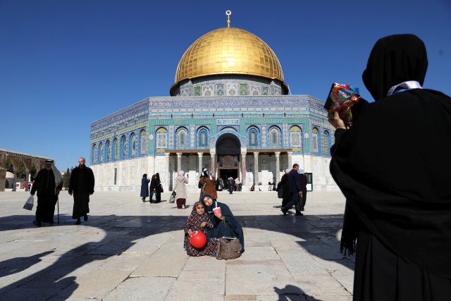 Turkish tourists pose for a photograph ahead of Friday prayers on the compound known to Muslims as Noble Sanctuary and to Jews as Temple Mount in Jerusalem's Old City, as Palestinians call for a "day of rage" in response to U.S. President Donald Trump's recognition of Jerusalem as Israel's capital December 8, 2017. REUTERS/Ammar Awad