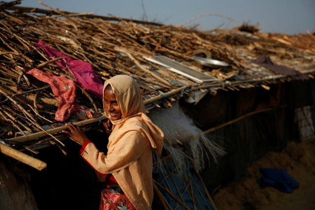 A Rohingya refugee woman stands at the door of her temporary shelter at the Thangkali refugee camp near Cox's Bazar, Bangladesh December 21, 2017. REUTERS/Alkis Konstantinidis