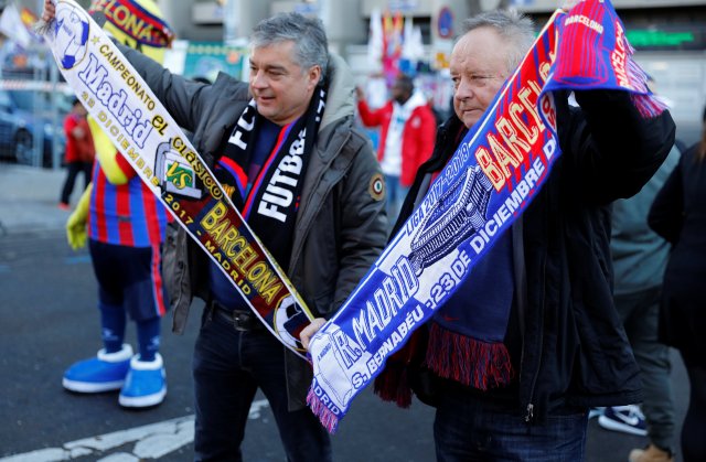 Soccer Football - La Liga Santander - Real Madrid vs FC Barcelona - Santiago Bernabeu, Madrid, Spain - December 23, 2017 Fans with scarves outside the stadium before the match REUTERS/Paul Hanna