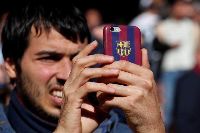 Soccer Football - La Liga Santander - Real Madrid vs FC Barcelona - Santiago Bernabeu, Madrid, Spain - December 23, 2017 Barcelona fan takes a photo before the match REUTERS/Paul Hanna