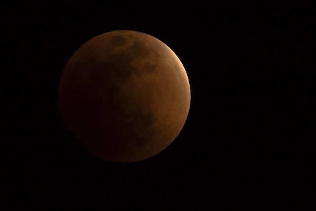 The moon is seen during a lunar eclipse, referred to as the "super blue blood moon", in Beijing on January 31, 2018. Skywatchers were hoping for a rare lunar eclipse that combines three unusual events -- a blue moon, a super moon and a total eclipse -- which was to make for a large crimson moon viewable in many corners of the globe. / AFP PHOTO / NICOLAS ASFOURI