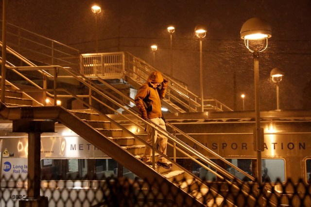 A man walks down the stairs during a blizzard to board the Long Island Railroad in Port Washington, New York, U.S. January 4, 2018. REUTERS/Shannon Stapleton