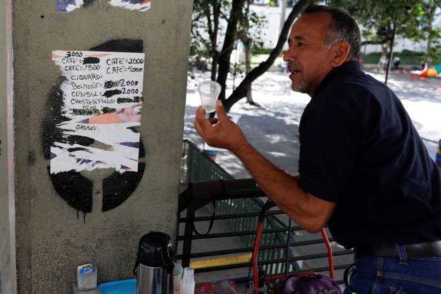 A man asks for the price of a cup of coffee in downtown Caracas, Venezuela January 9, 2018. REUTERS/Marco Bello