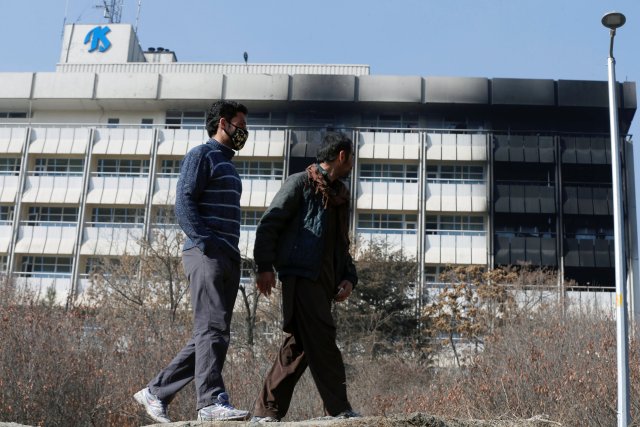 Afghan men look at the Intercontinental Hotel a day after an attack in Kabul, Afghanistan January 22, 2018. REUTERS/Omar Sobhani