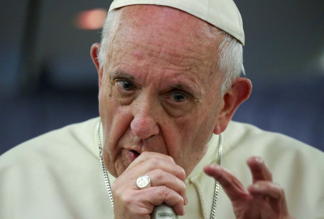 Pope Francis gestures during a news conference on board of the plane during his flight back from a trip to Chile and Peru, January 22, 2018. REUTERS/Alessandro Bianchi