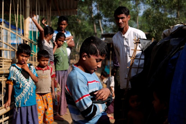 Md Idris, 10, Rohingya refugee boy, who said he was shot by the Myanmar military four months ago, poses for photo at Kutupalong refugee camp near Cox's Bazar, Bangladesh January 4, 2018. Picture taken January 4, 2018. REUTERS/Tyrone Siu