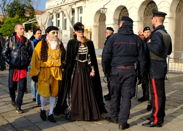 A masked reveller is controlled by Italian Carabinieri during the Venice Carnival, Italy, February 4, 2018. REUTERS/Manuel Silvestri