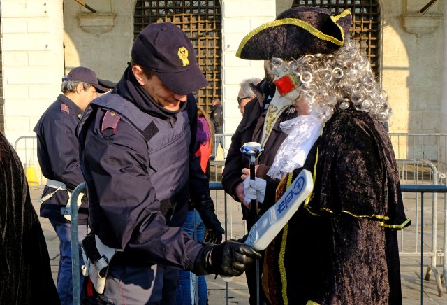 A masked reveller is controlled by an Italian Policeman during the Venice Carnival, Italy, February 4, 2018. REUTERS/Manuel Silvestri TPX IMAGES OF THE DAY