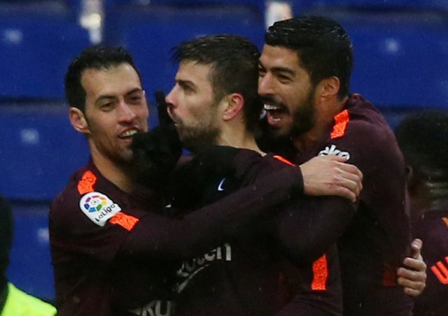 Soccer Football - La Liga Santander - Espanyol vs FC Barcelona - RCDE Stadium, Barcelona, Spain - February 4, 2018 Barcelona’s Gerard Pique celebrates with Sergio Busquets and Luis Suarez after scoring their first goal REUTERS/Albert Gea