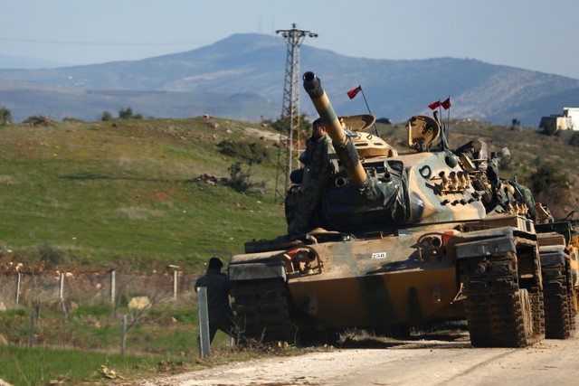 Turkish soldiers stand next to a tank near the Turkish-Syrian border in Kilis province, Turkey January 31, 2018. REUTERS/Osman Orsal