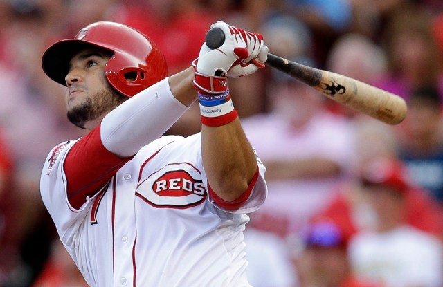 Cincinnati Reds' Eugenio Suarez hits a sacrifice fly off Pittsburgh Pirates starting pitcher Gerrit Cole to drive home Marlon Byrd in the second inning of a baseball game, Saturday, Aug. 1, 2015, in Cincinnati. (AP Photo/John Minchillo)