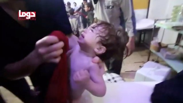 A child cries as they have their face wiped following alleged chemical weapons attack, in what is said to be Douma, Syria in this still image from video obtained by Reuters on April 8, 2018. White Helmets/Reuters TV via REUTERS THIS IMAGE HAS BEEN SUPPLIED BY A THIRD PARTY.