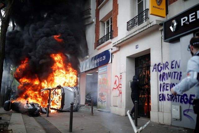 Un automóvil se quema frente a un garaje de automóviles de Renault durante los enfrentamientos durante la marcha del sindicato del Primero de Mayo en París, Francia, el 1 de mayo de 2018. REUTERS / Christian Hartmann